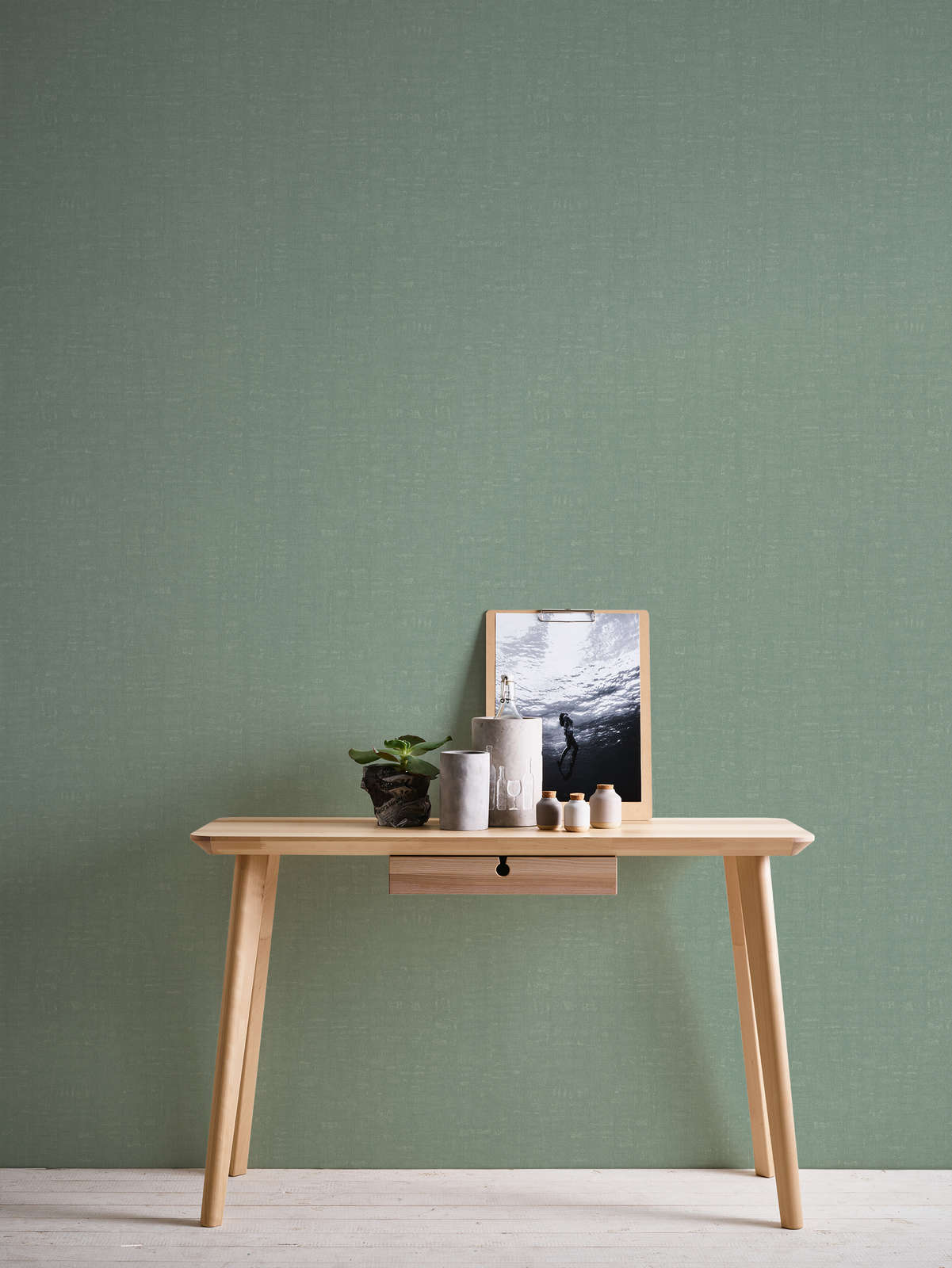             Green wallpaper plain and mottled with texture embossing
        