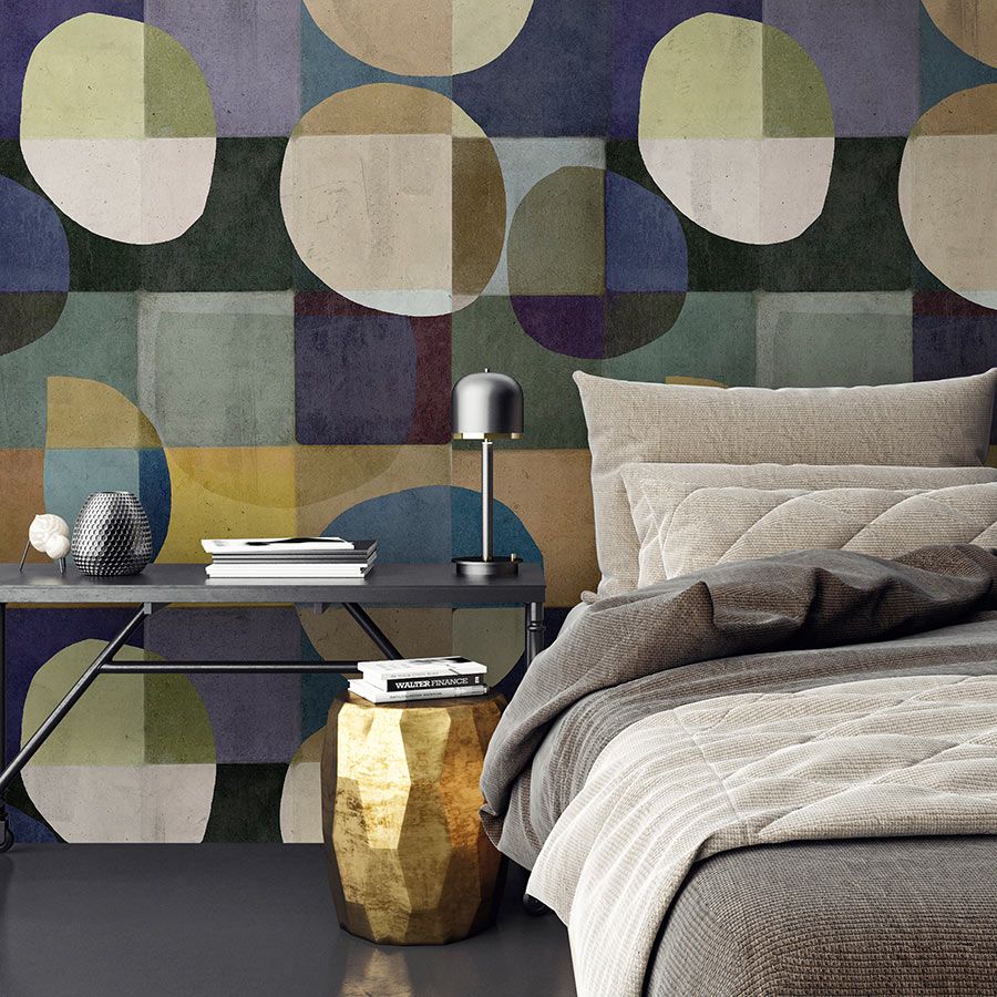 Photo wallpaper »luna« - Colourful retro pattern in front of concrete plaster look - Green , Blue Yellow, Beige | Matt, Smooth non-woven fabric
