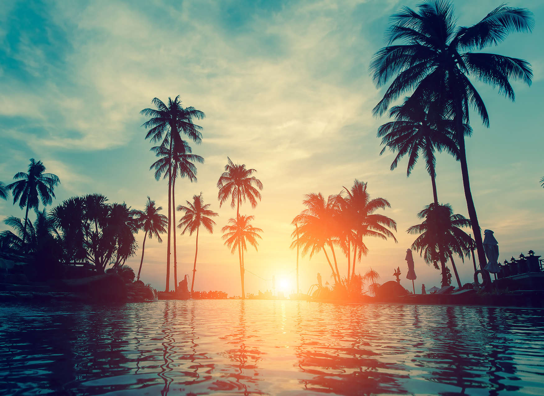             Photo wallpaper with palm trees on the water in the sunset - blue, orange, black
        