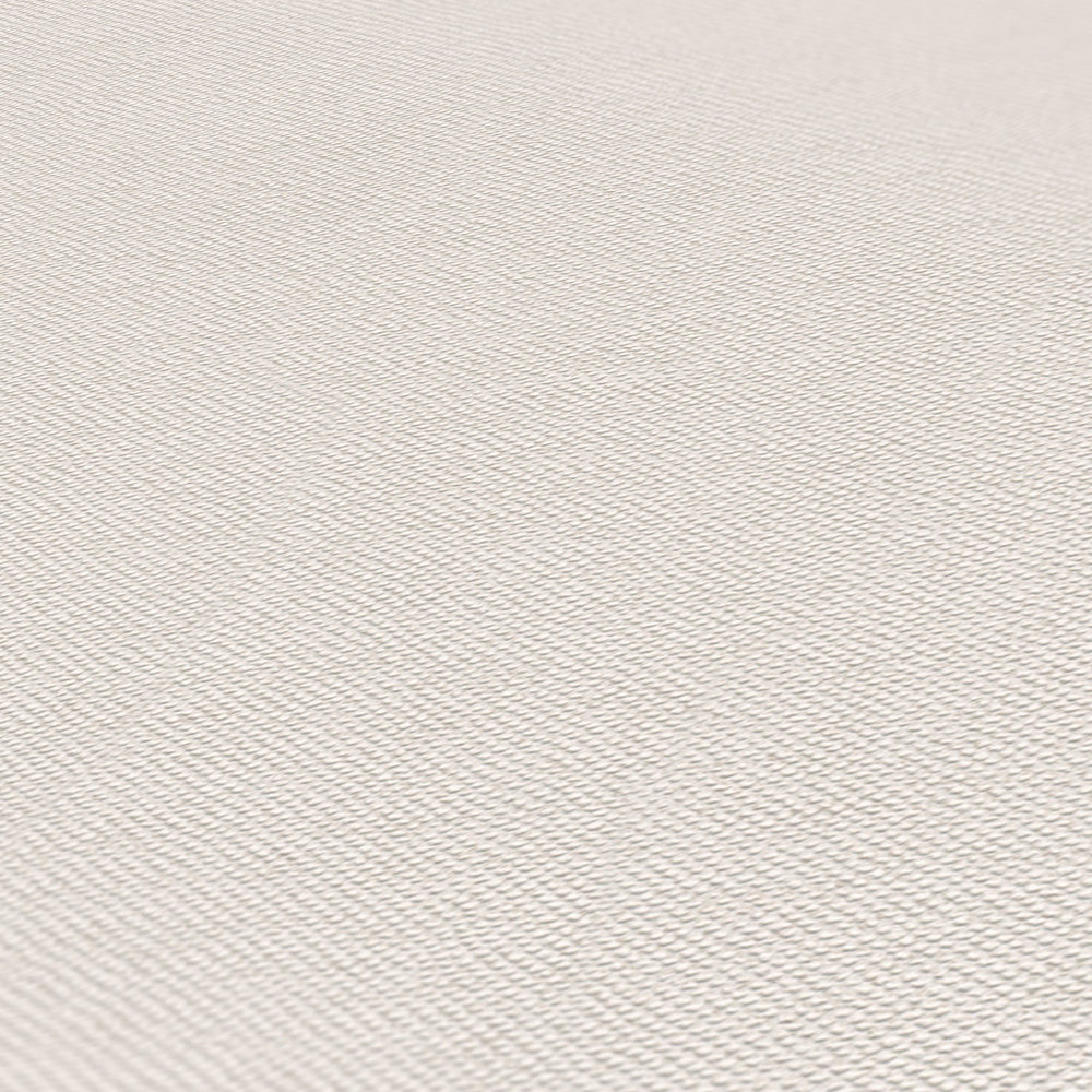             Effen behangpapier crème met textielstructuur in elegant design
        