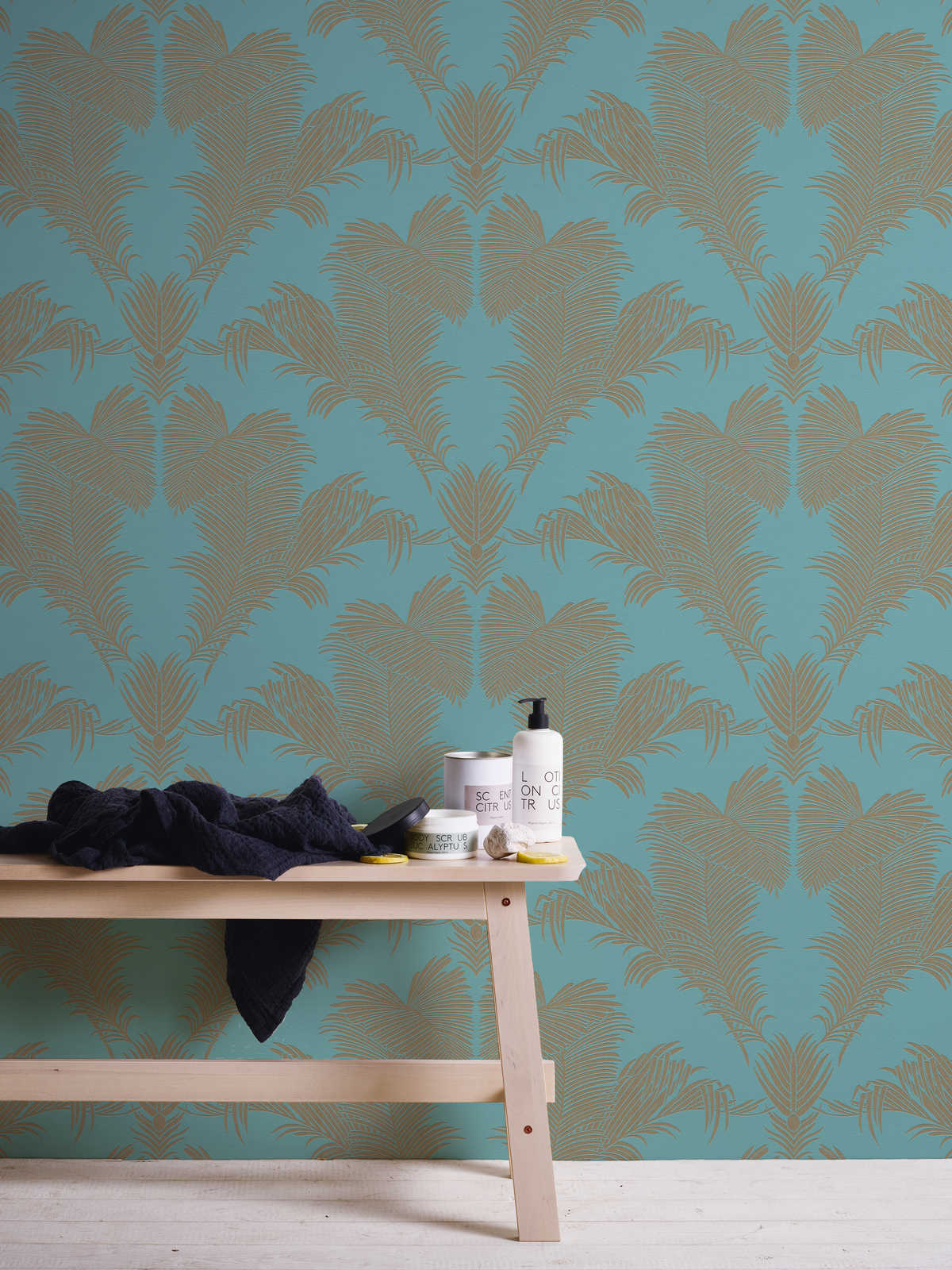             Turquoise non-woven wallpaper with leaf motif in metallic gold
        