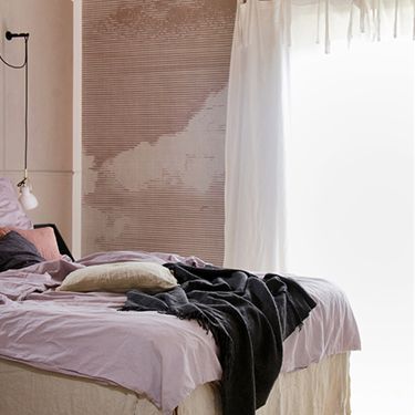 Bedroom with discreet photo wallpaper wall with clouds motif DD113782
