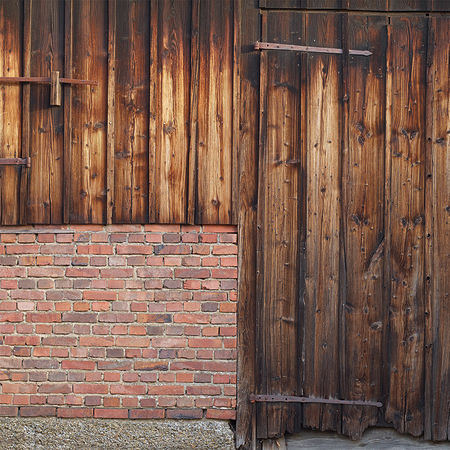Photo wallpaper red brick wall with wooden planks and barn door
