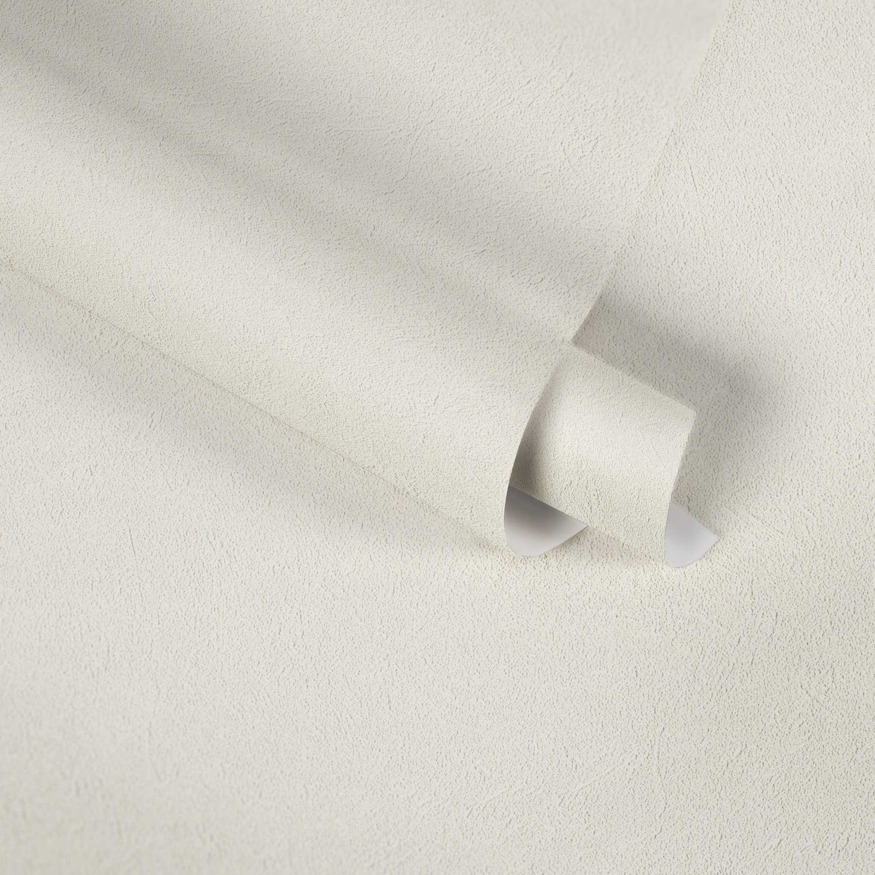             Papier peint uni crème-blanc avec un design structuré discret
        