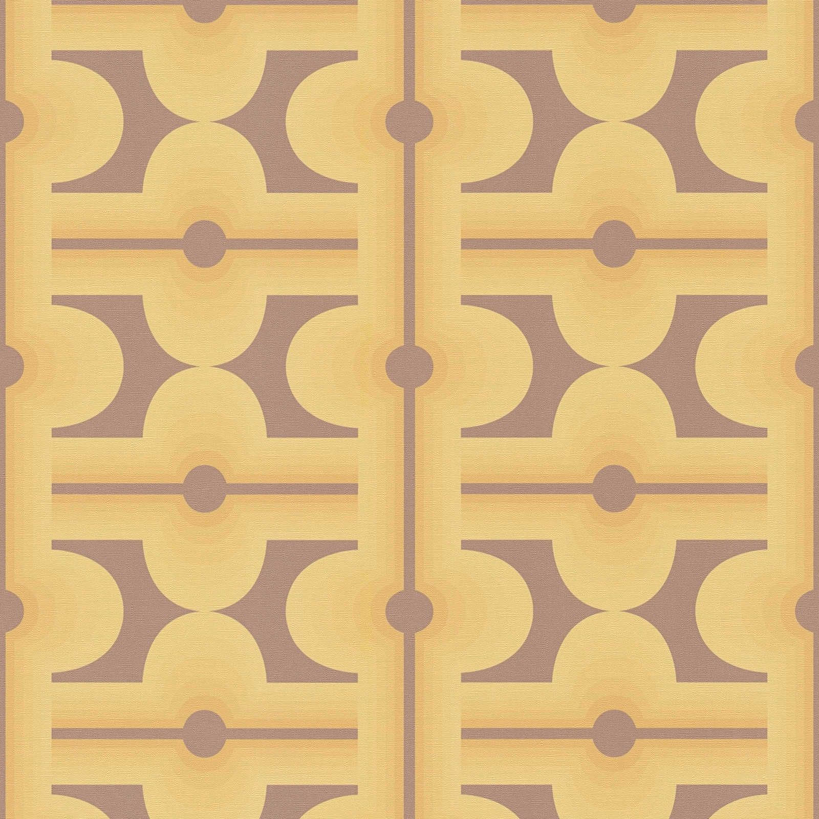 Abstract patterns on 70s non-woven wallpaper in warm colours - brown, yellow, orange
