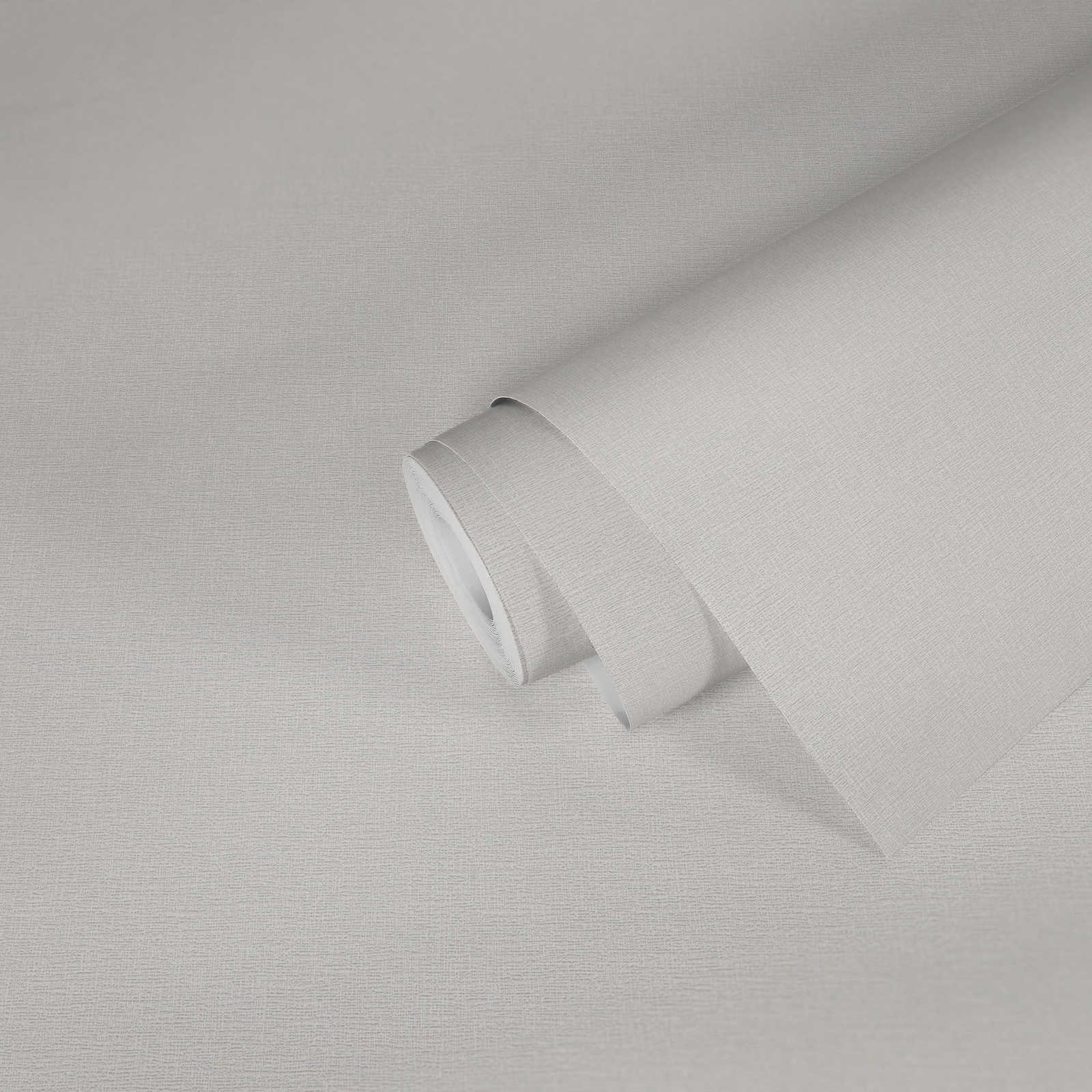             Papier peint crème uni avec structure naturelle
        