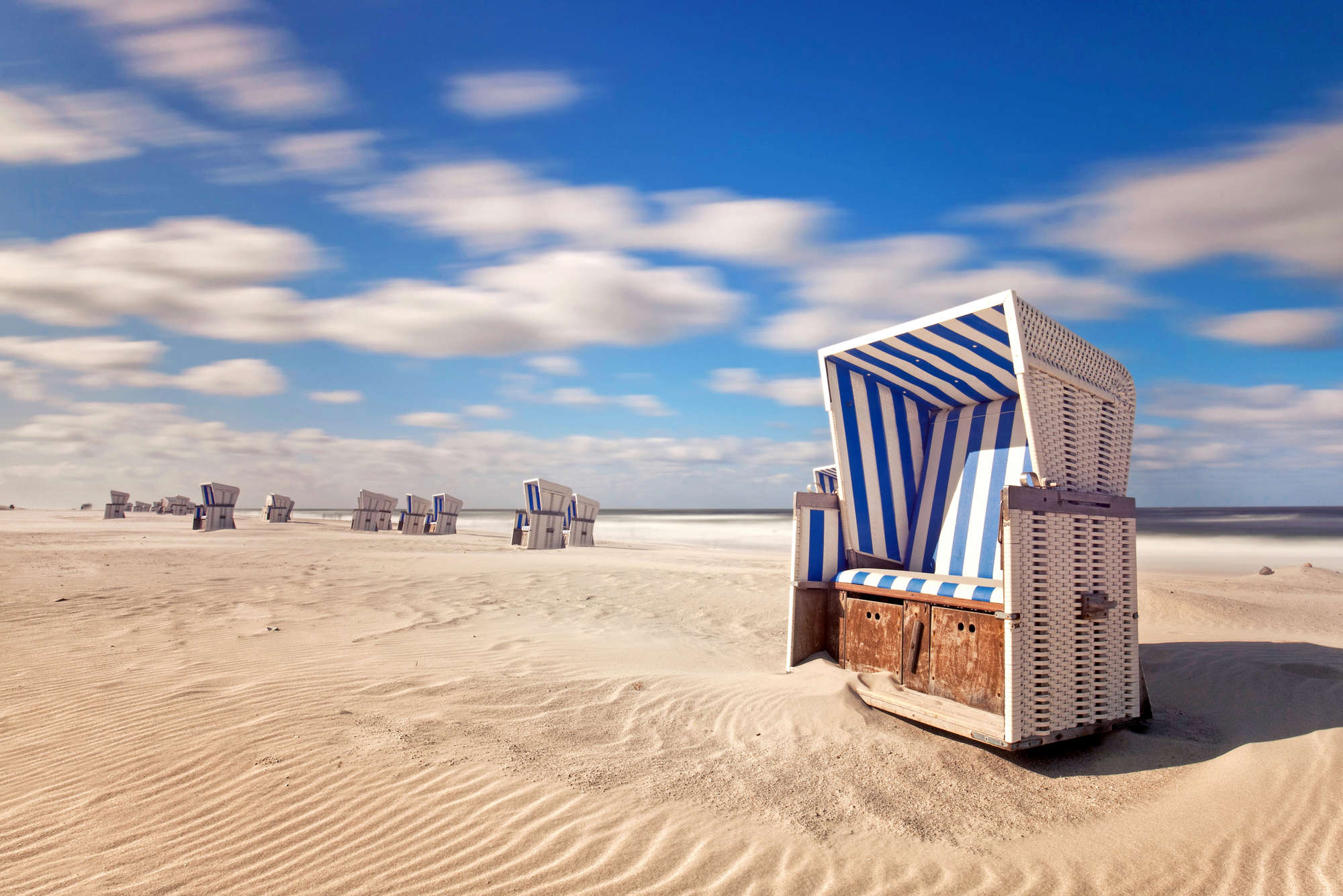             Beach mural beach chairs in the sand on matte smooth nonwoven
        