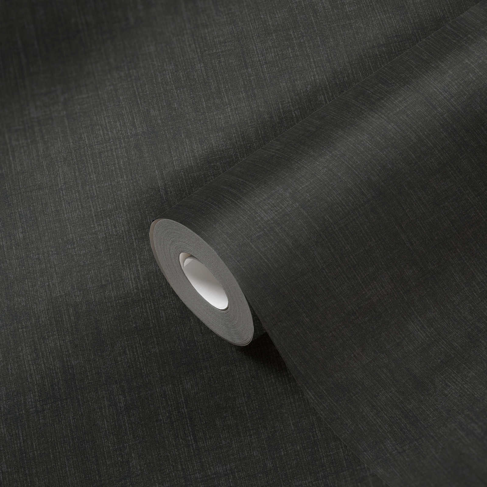            Black non-woven wallpaper with mellow textile pattern
        