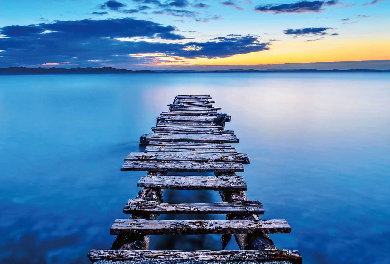 Photo wallpaper old pier in the lake - blue, yellow, grey
