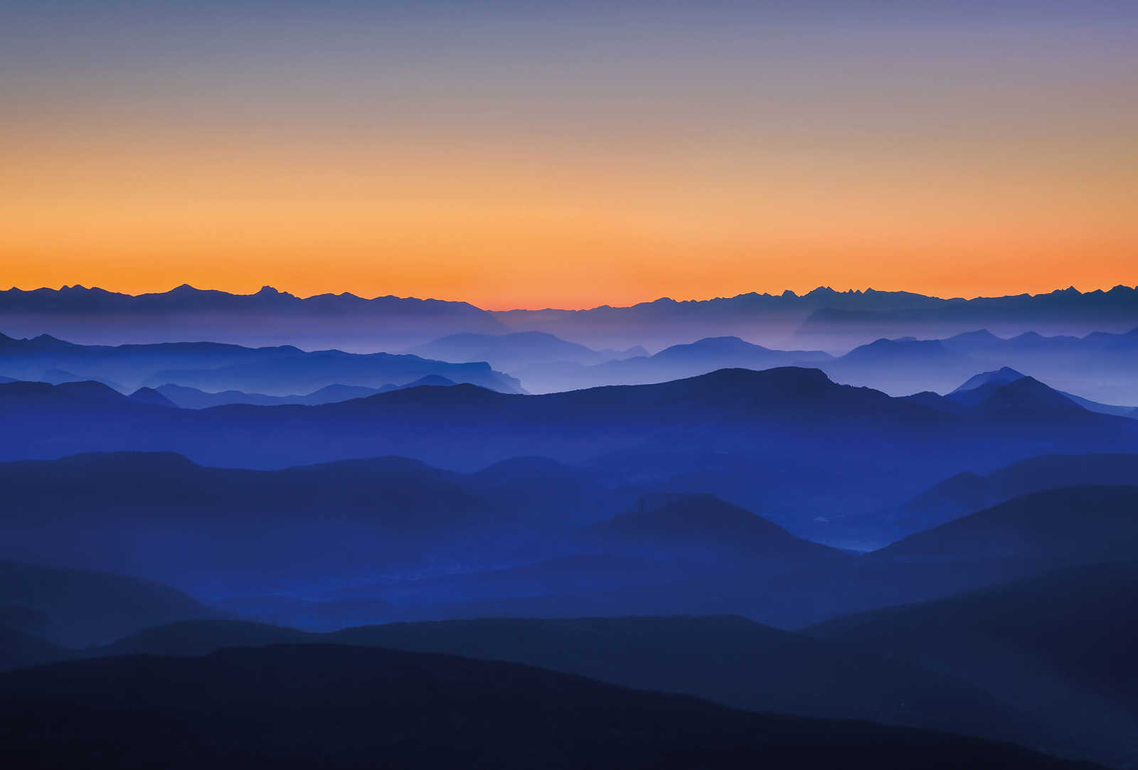 Photo wallpaper mountains at sunrise - blue, orange, yellow
