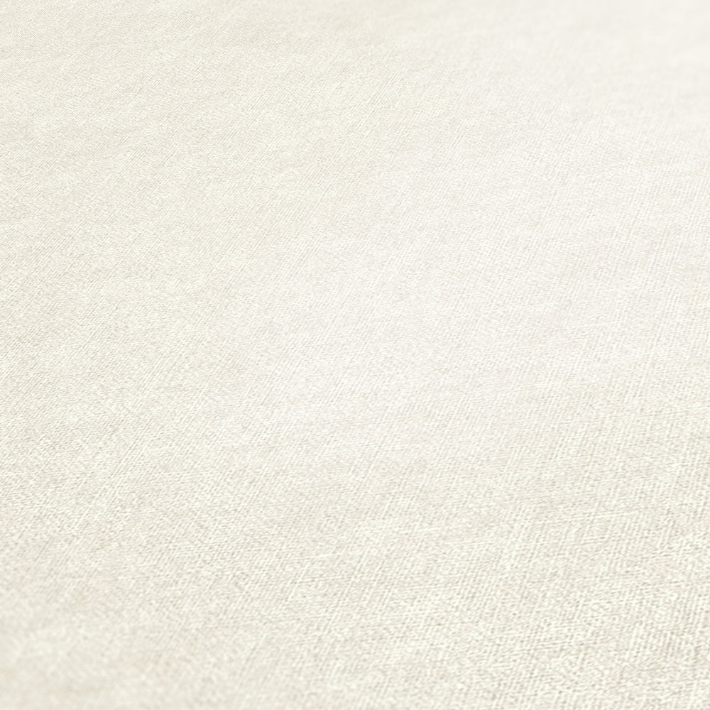             Papier peint uni blanc crème, mat avec motifs structurés
        