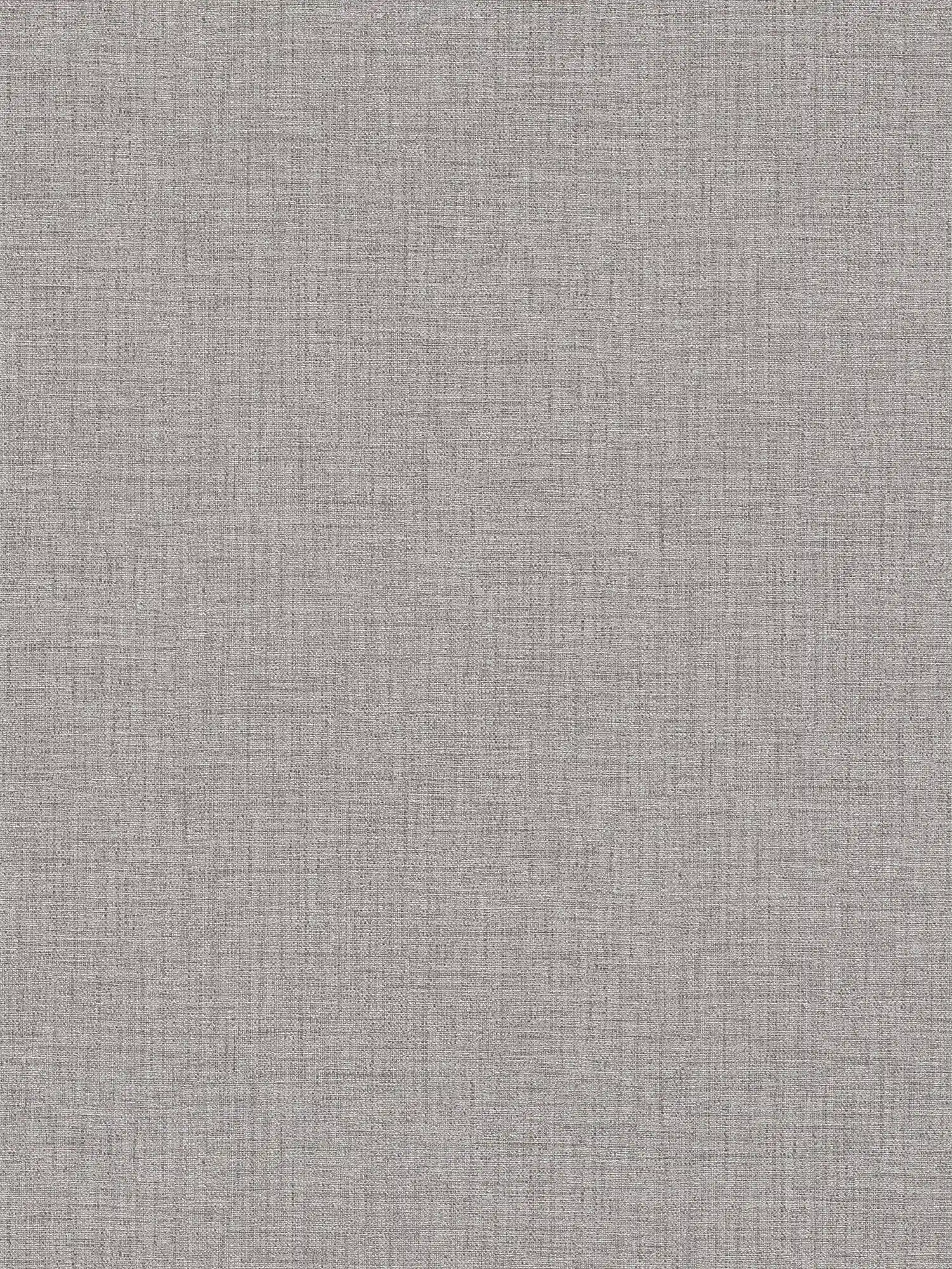 Papel pintado gris con estructura textil y efecto moteado
