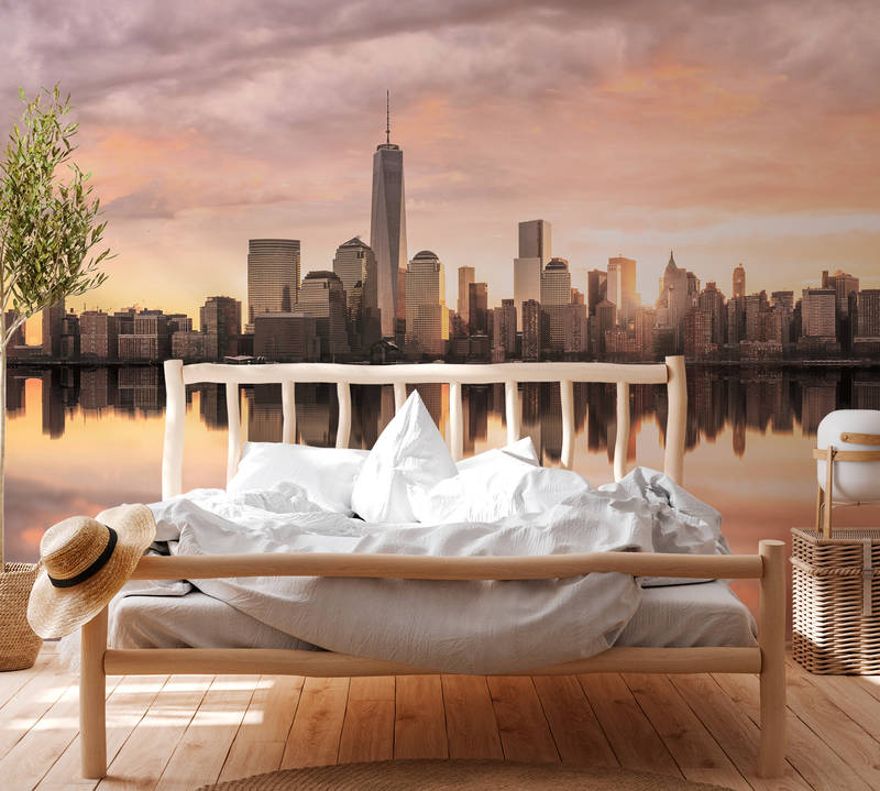             Muurschildering New York Skyline in de Avond - Grijs, Oranje, Geel
        