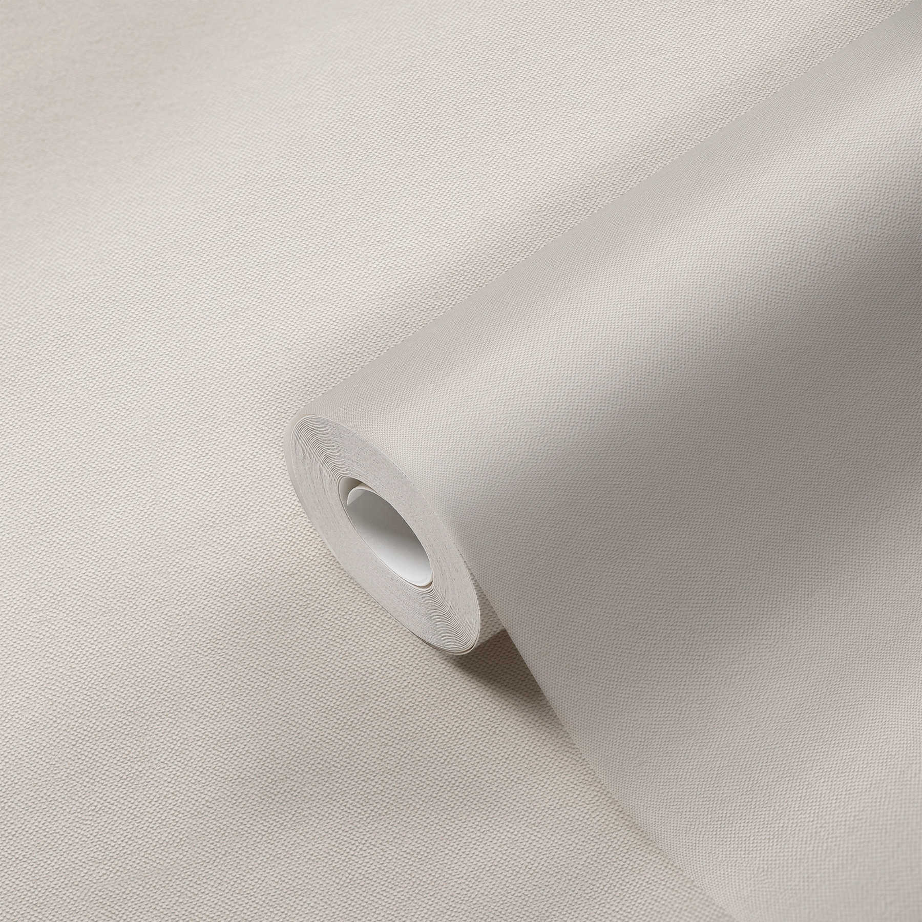             Effen behangpapier crème met textielstructuur in elegant design
        