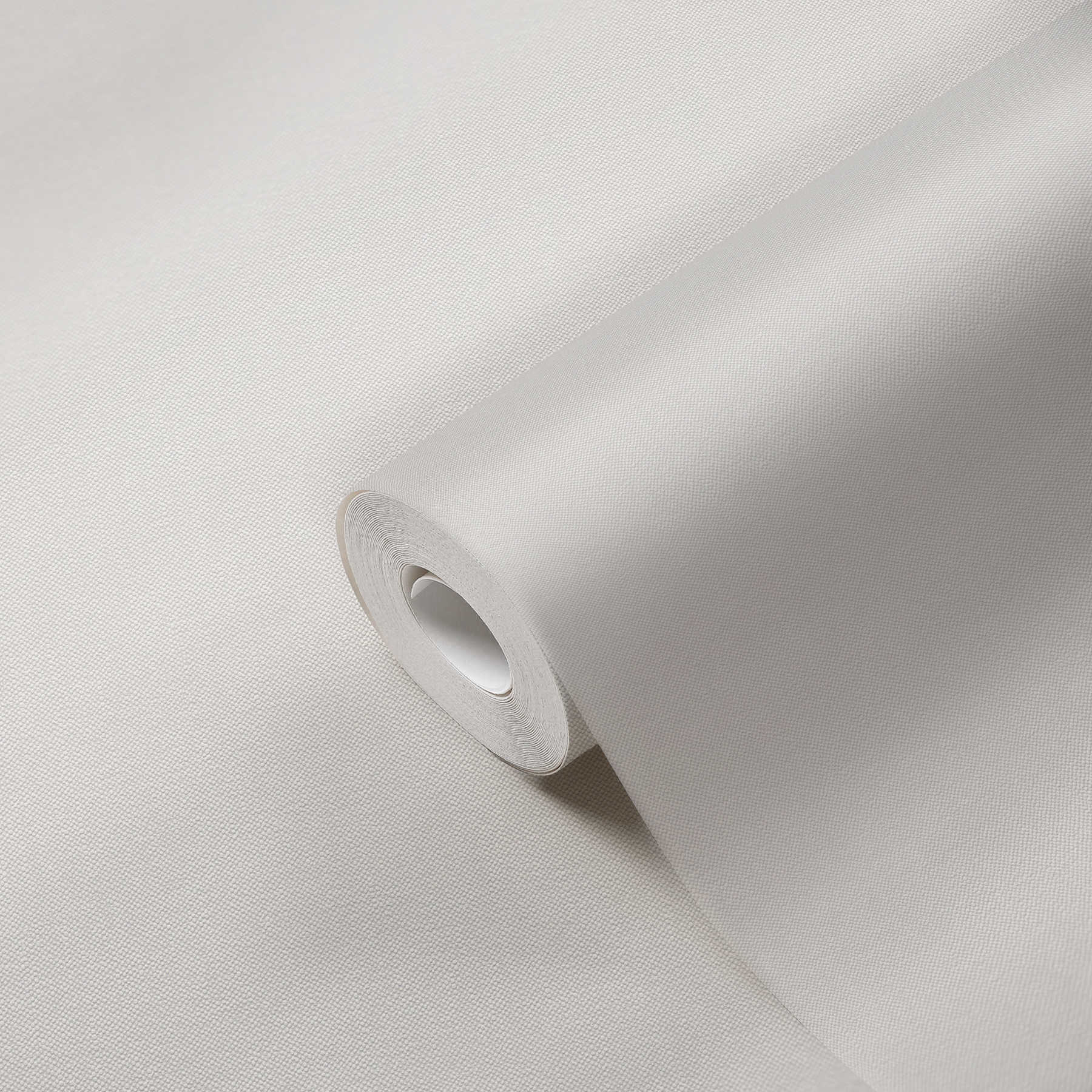             Carta da parati crema effetto lino con struttura tessile
        