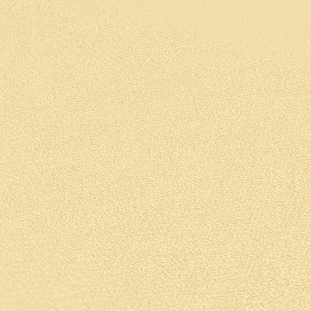             Effen vliesbehang in een warme tint - geel
        