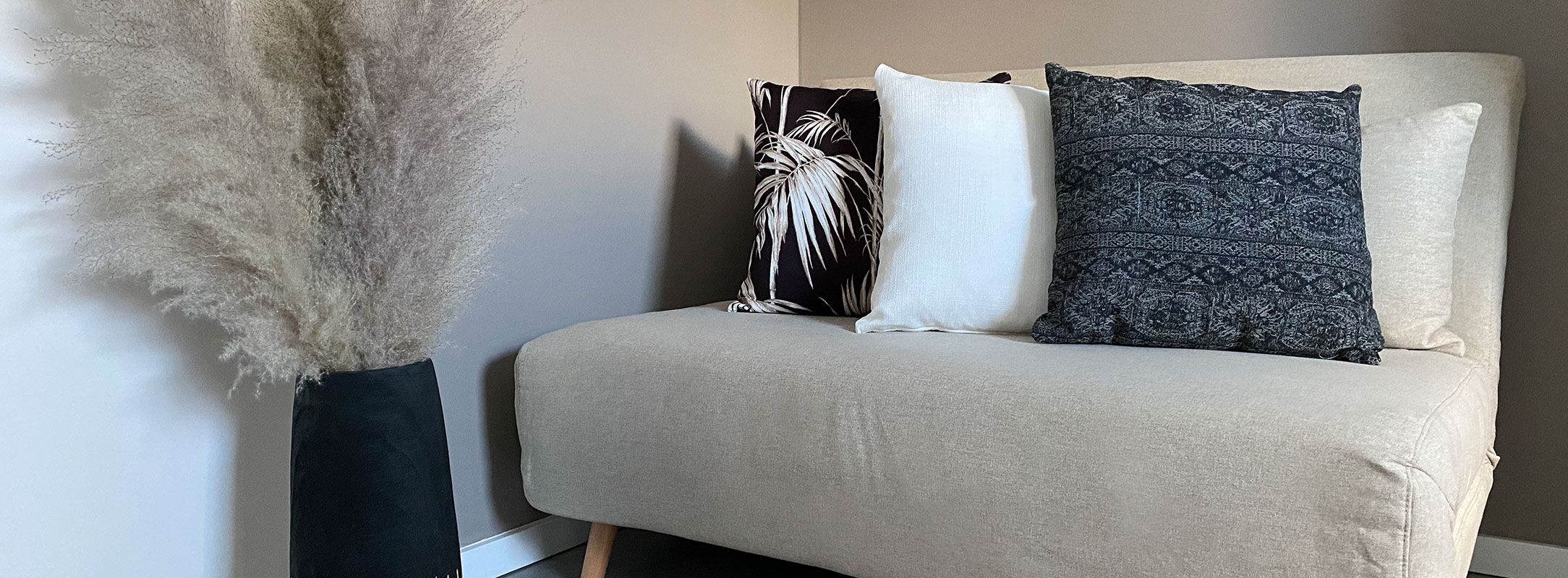 Three Japandi design cushions on beige couch