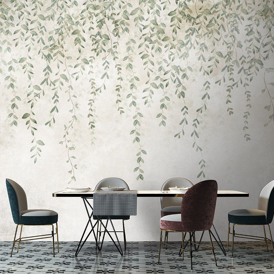 Photo wallpaper »kerala« - Garland of leaves in front of concrete plaster texture - Smooth, slightly pearlescent non-woven fabric
