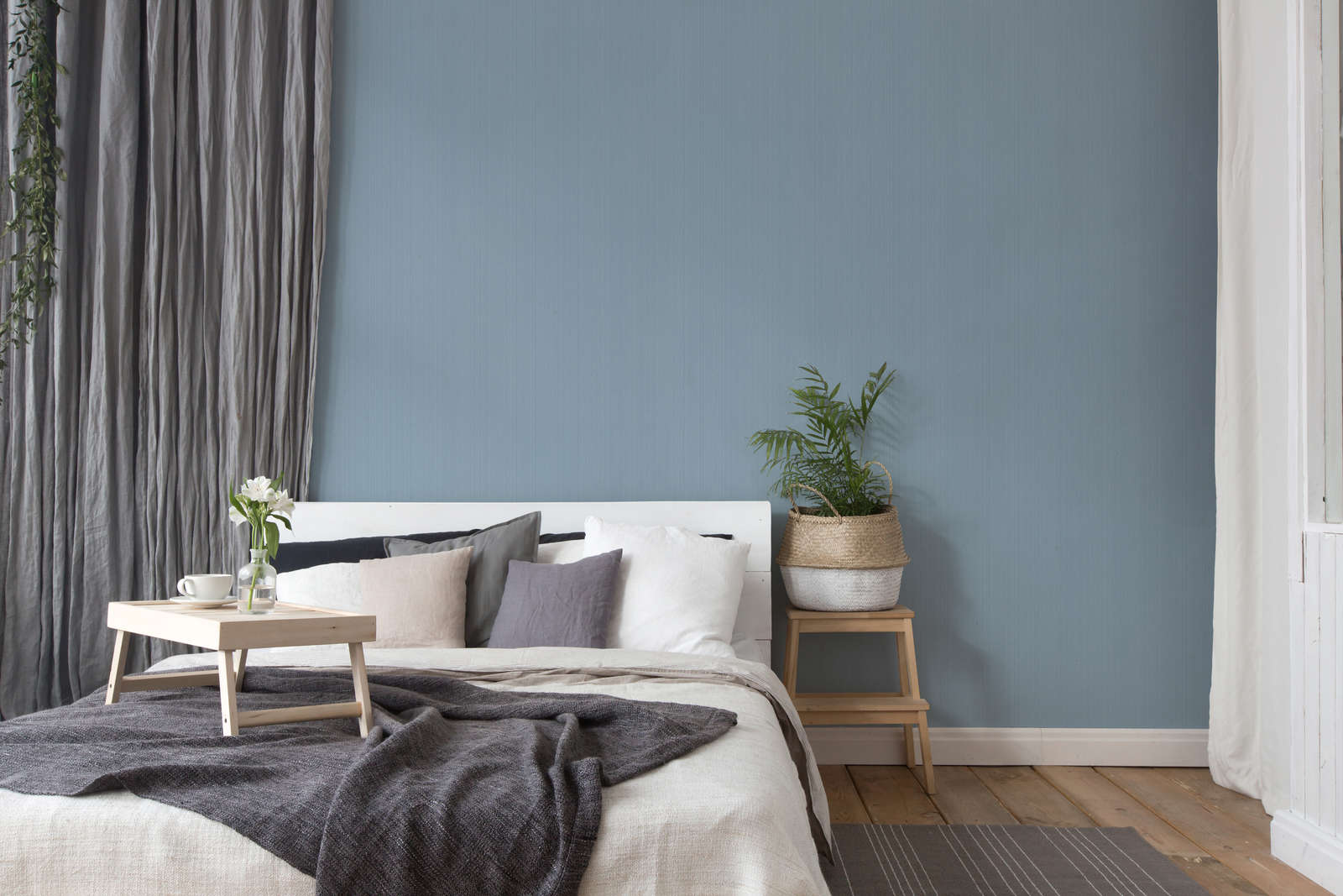             Blue non-woven wallpaper plain, satin with texture effect
        