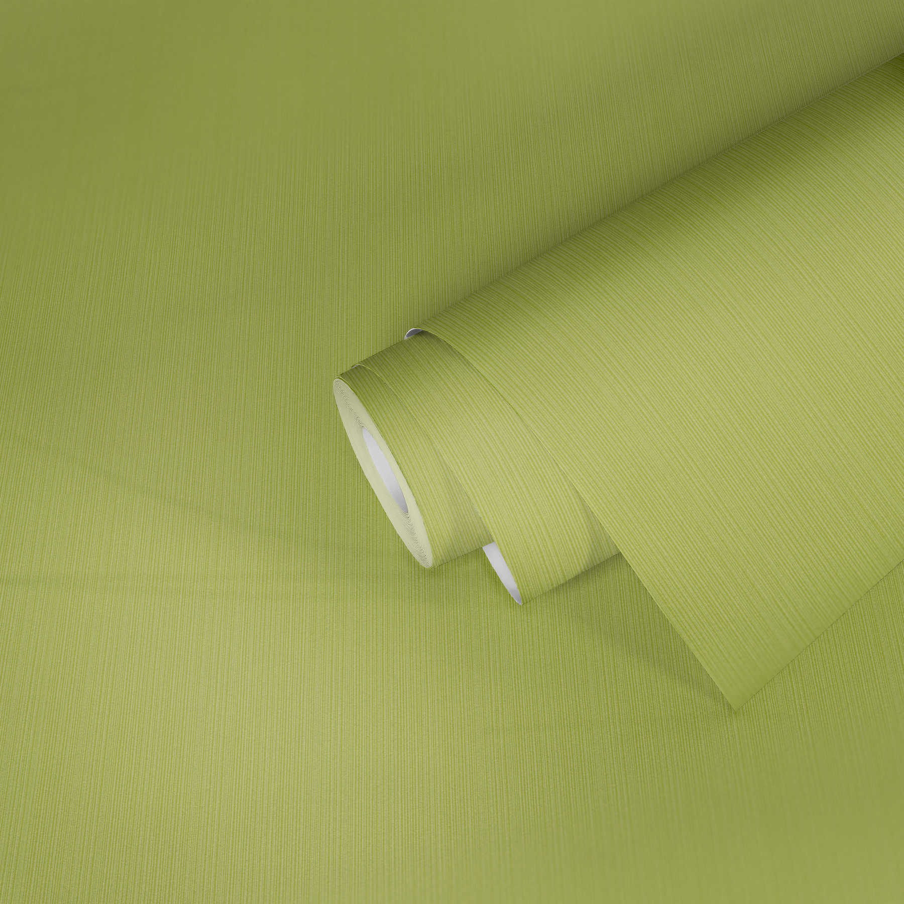             Carta da parati verde lime uni, con effetto texture a righe
        